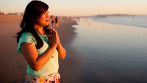 Kavita standing on the beach reflecting